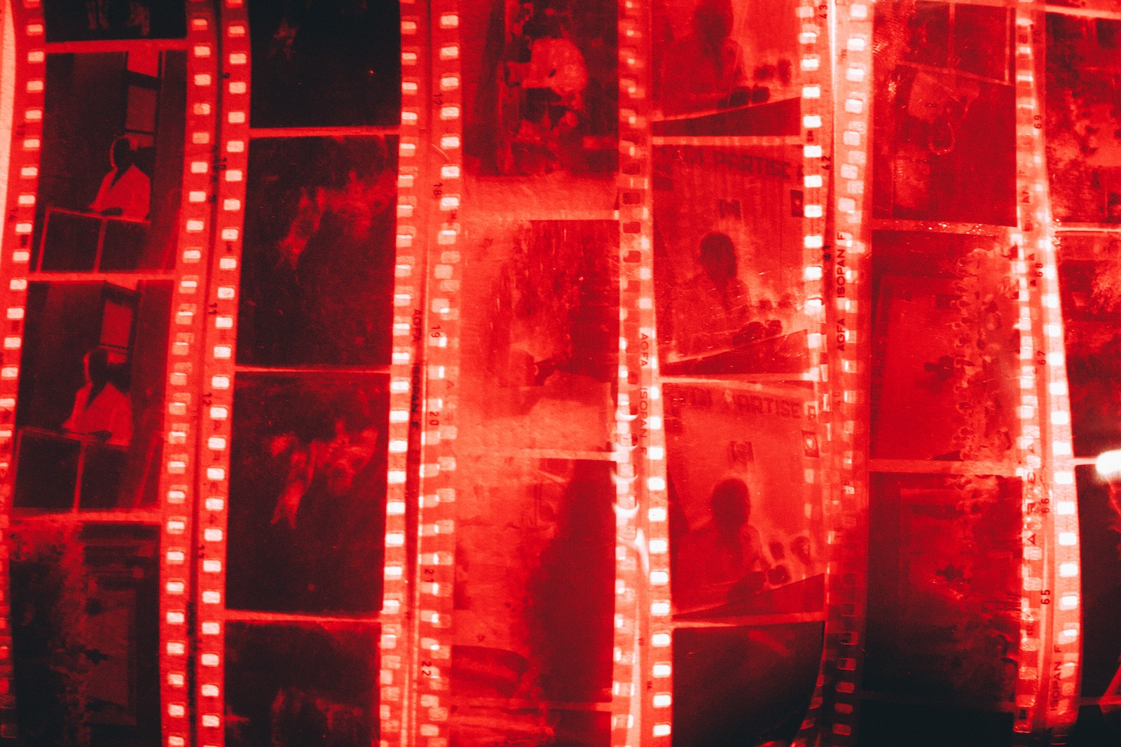 a man standing in front of a wall of film